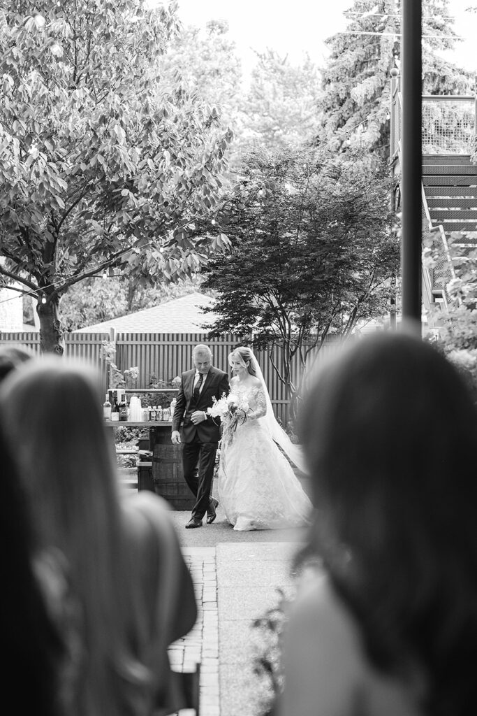 Bride and father walking down the aisle together at Firehouse Chicago ceremony.