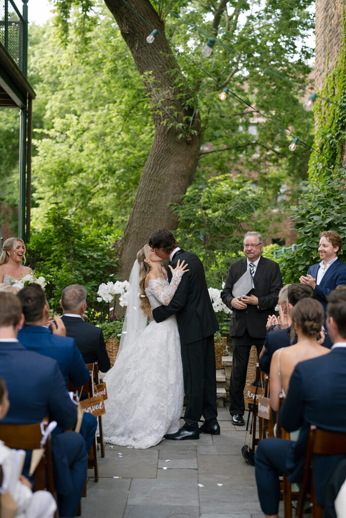 Bride and groom kissing at the altar during their Chicago Firehouse micro wedding ceremony