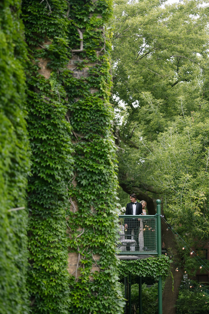 Bride and groom posing on the balcony at Chicago Firehouse for their micro wedding portraits
