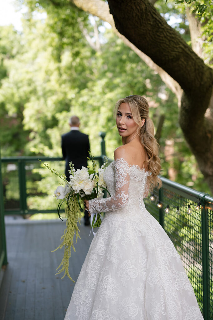 Bride looking back at the camera about to share a first look with her father