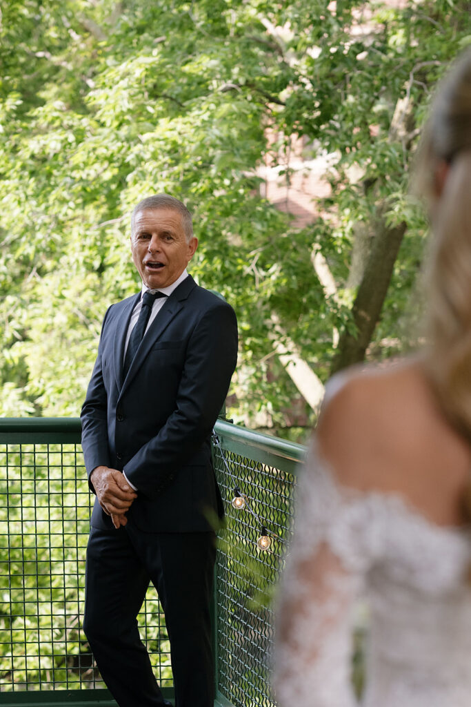 Brides father turning around during a first look in awe of his daughter