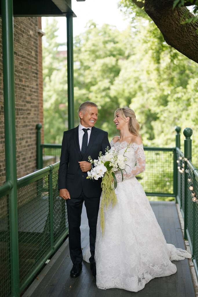 Bride and her father laughing and walking together