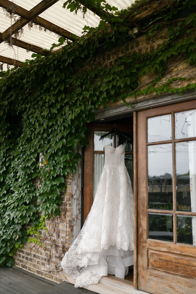 Brides wedding dress hanging on the door at Chicago Firehouse
