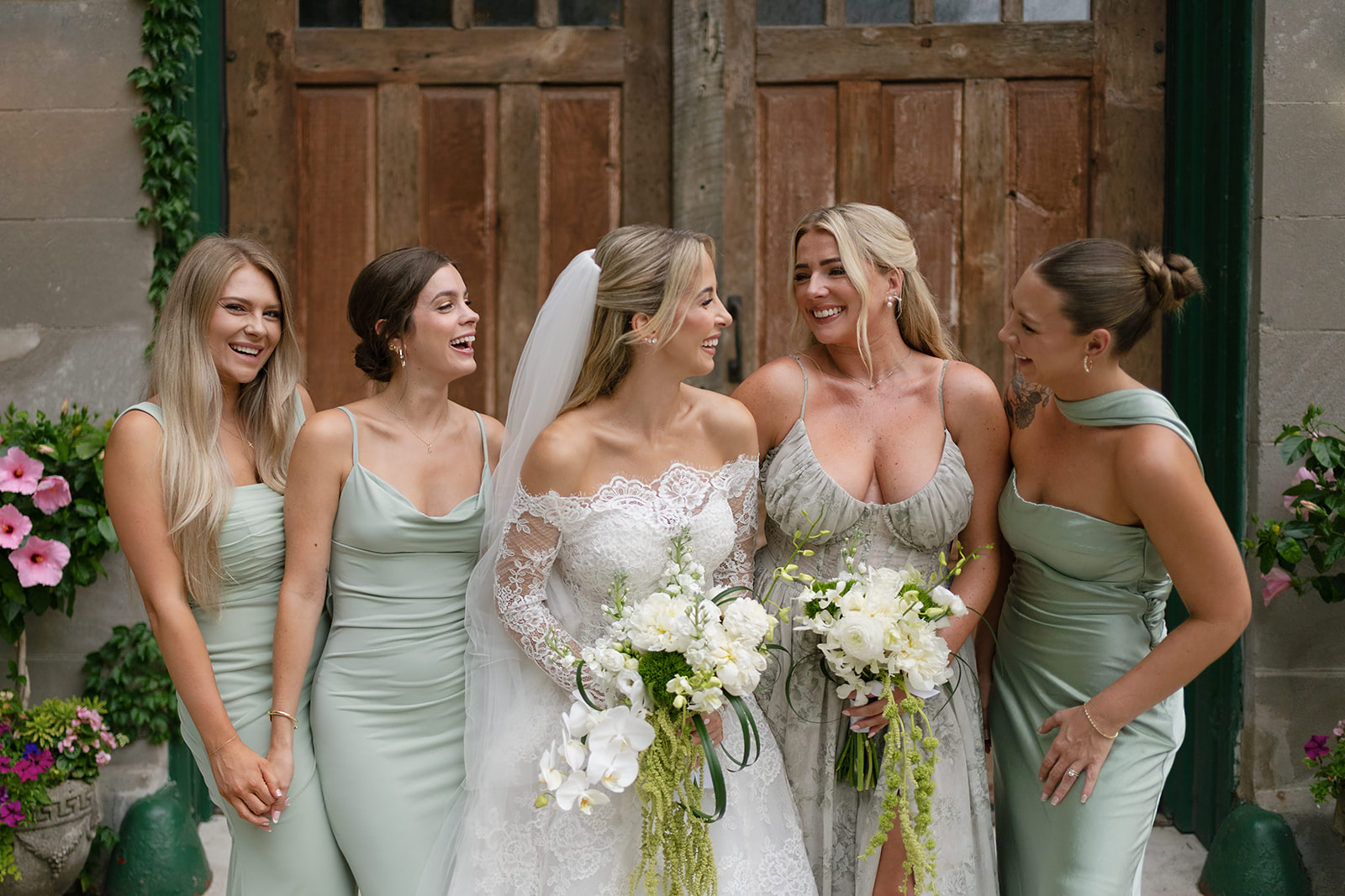 Wide shot of a bride and bridesmaids posing outside of Chicago Firehouse