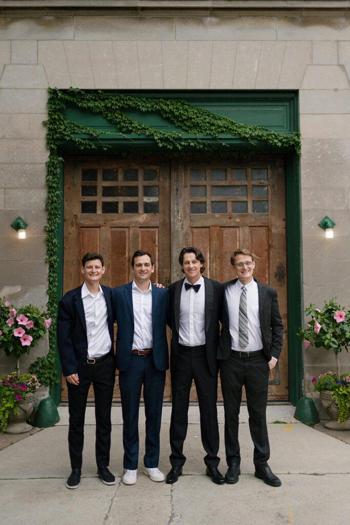 Groom and a few of his groomsmen posing for portraits outside of Firehouse Chicago